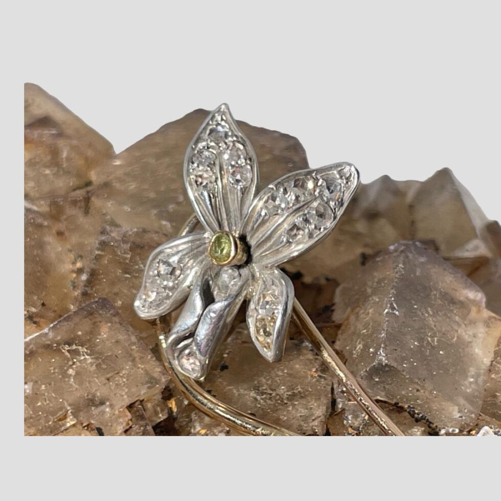 Another close up of the orchid flower head this time turned towards the left. The brooch is still displayed on a rock of natural river quartz.