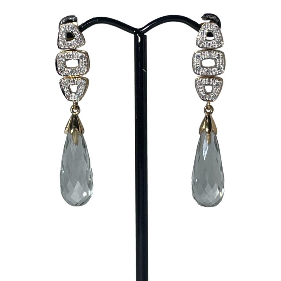 A photo of the gold aquamarine and diamond earrings this time displaayed with a plain white background and forward facing. The colour of the stones appear a pale greyish blue here.