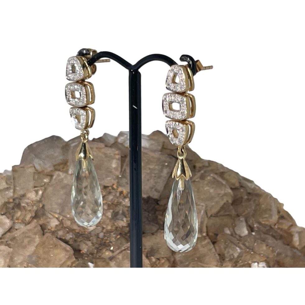 Photo of aquamarine diamond earrings this time with the earring fronts facing to the bottom left corner.