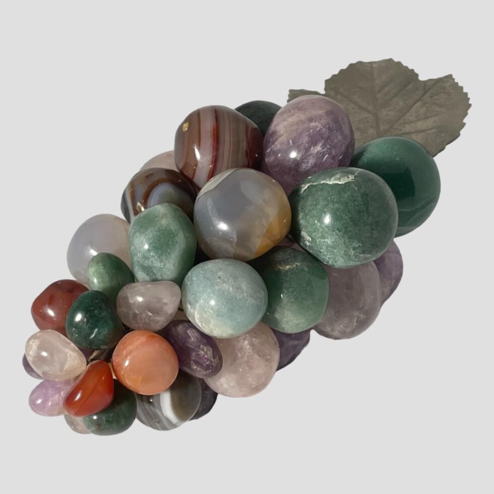 Photo of the vintage semi-precious bead grapes this time seen with the tip end in the left foreground and leaf end in top right. This end with the smaller grapes has the most assorted stones and colours.