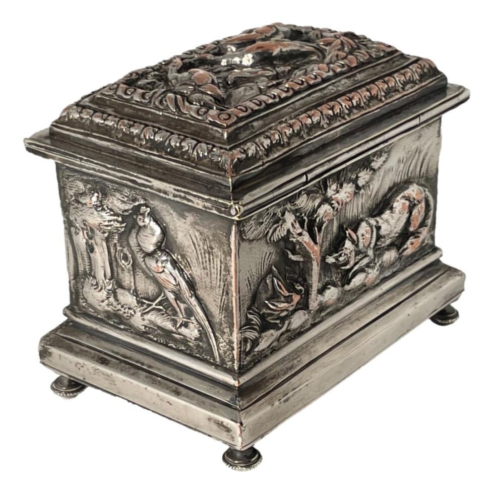 The casket has now been turned a little clockwise so the single bird (peacock?) is now in the bottom left corner. The back panel of the casket shows a hare on the left behind a tree with a fox crouched down on the right appearing to be ready to pounce.