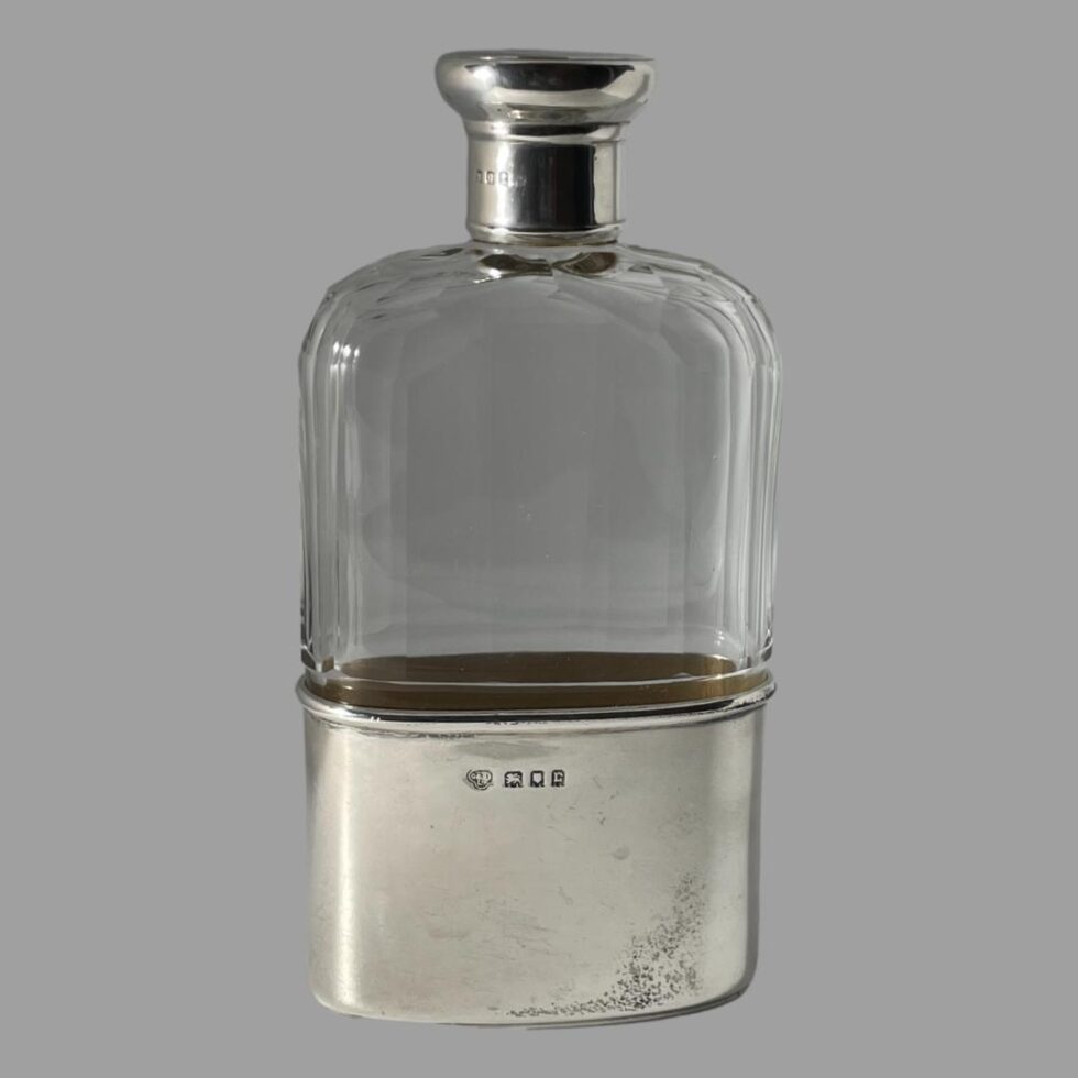 Photo of hip flask seen from an eye level this time with the hallmarked base facing forward.