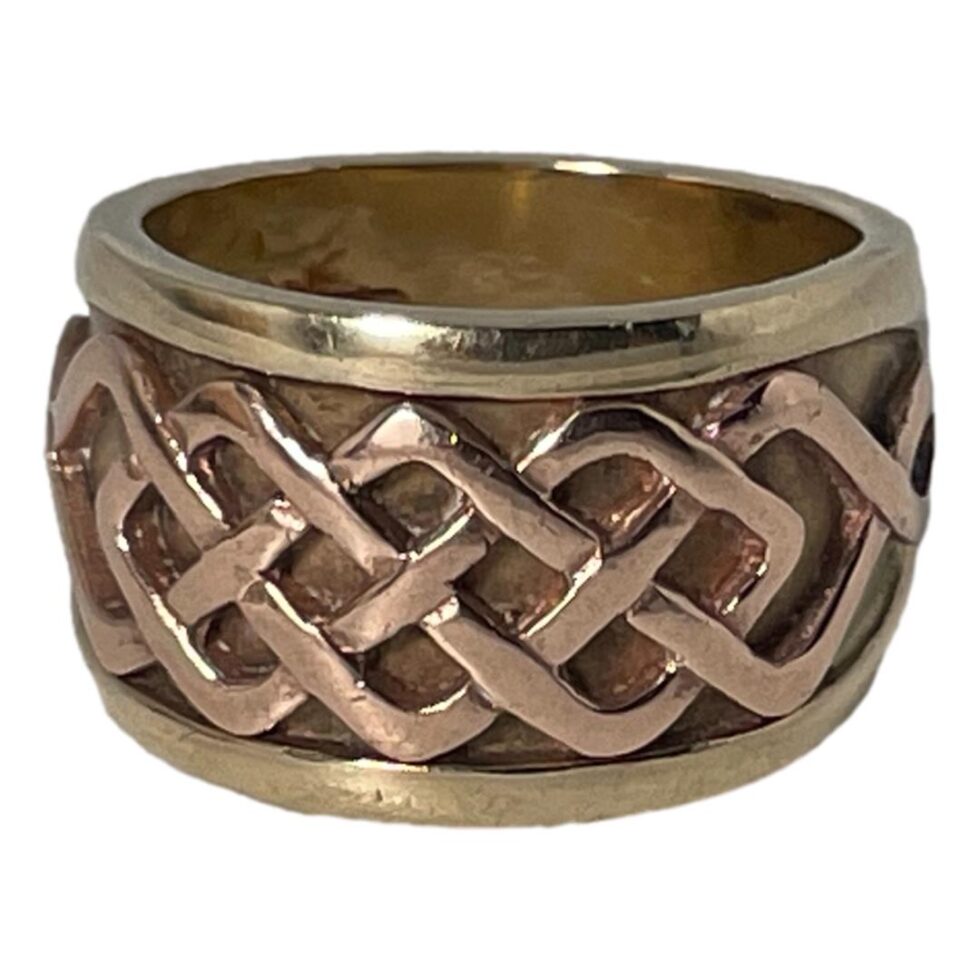 Photo of Clogau ring displayed on a plain white surface with the ring front forward facing.