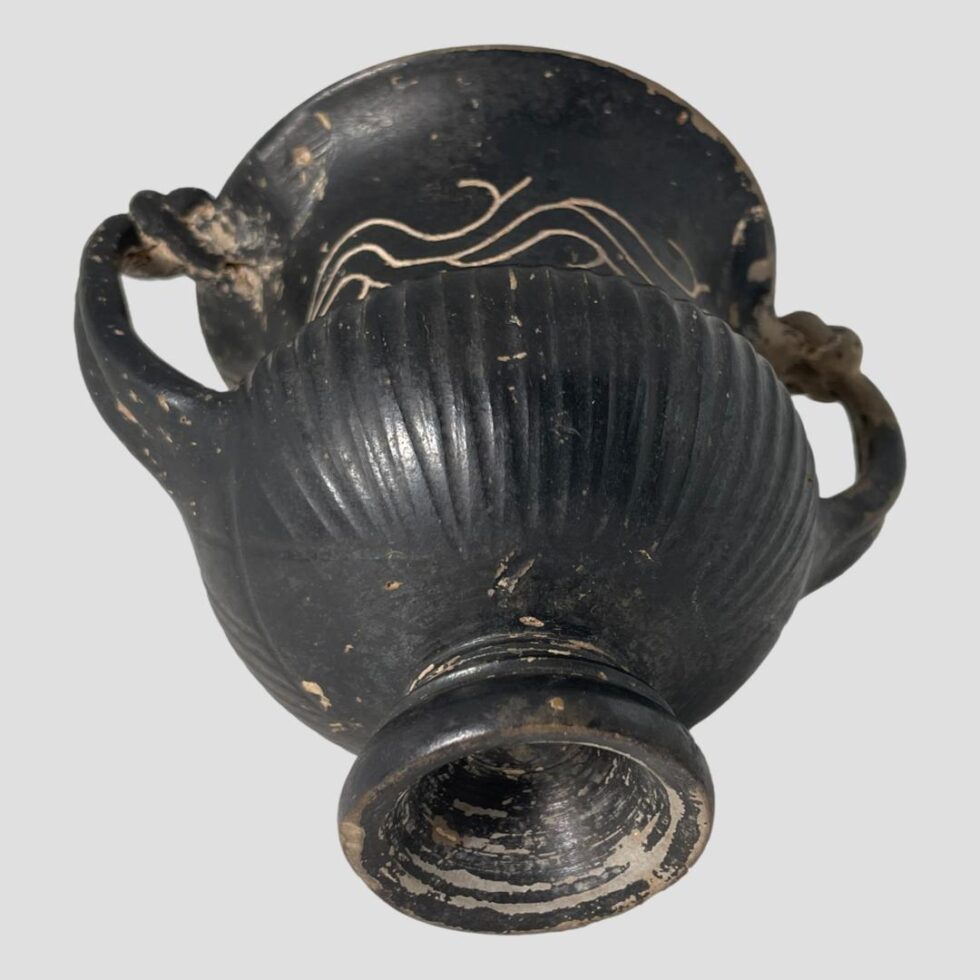 Photo of the urn laid flat and showing the lower area and base.