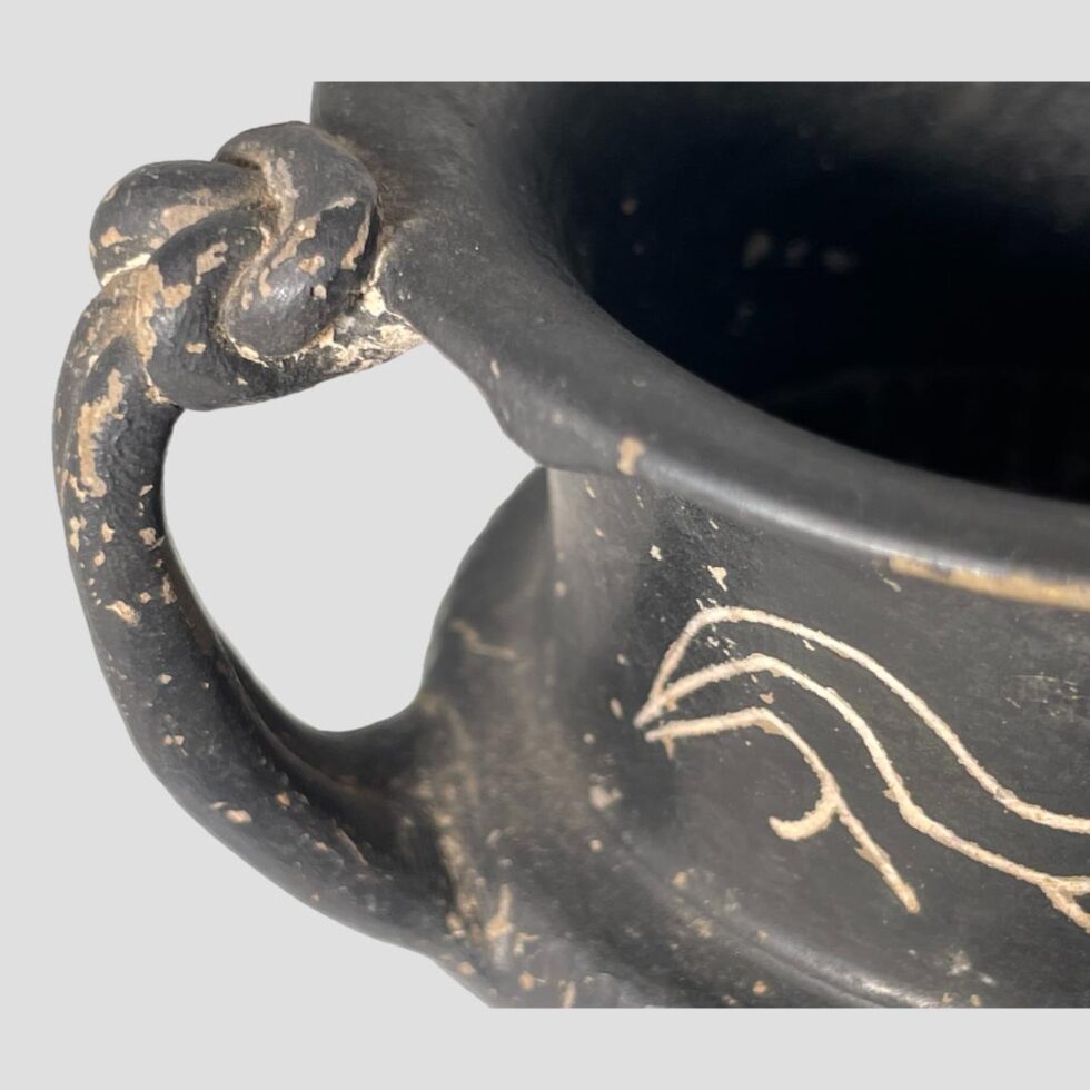 A close up photo of one of the knotwork snakehead handle tops.
