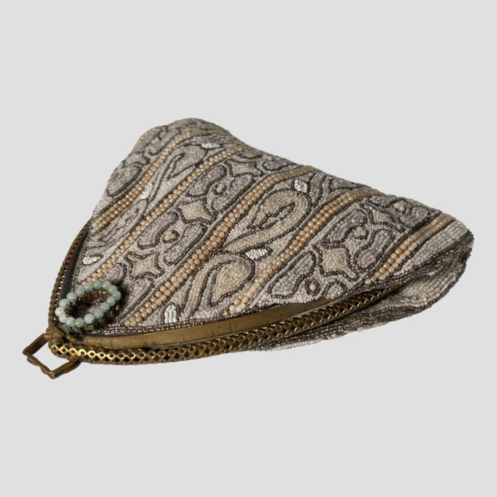 Photo of Parisian bag laid flat with the pointed clasp end in the bottom left corner and with beaded clasp end up. The beads continue to the sides of the bag. There is not much room inside - definitely will not fit a small smart phone (I tried!) One for taking to the opera maybe with gloves and small eye glasses perhaps.