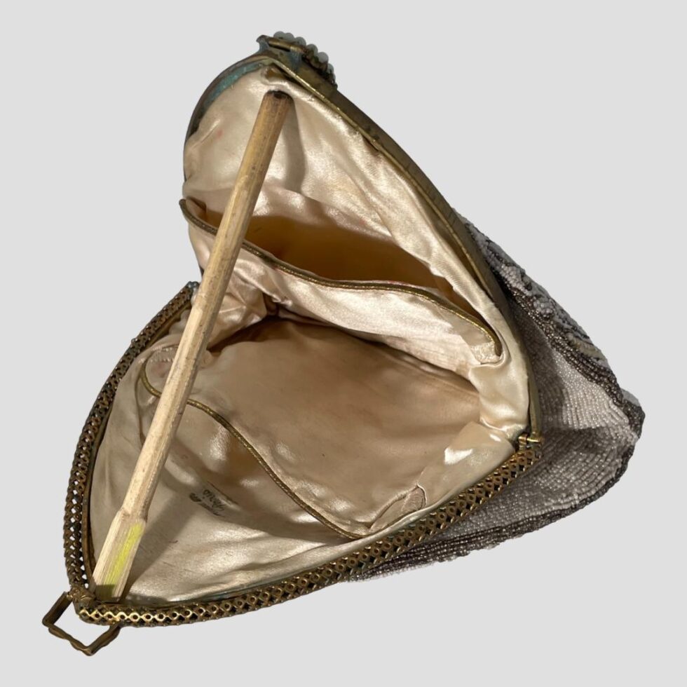 Photo of 1930s beaded bag shown open unceremoniously with a bit of chopstick! Inside, the creamy silk interior has a small pocket on either side.
