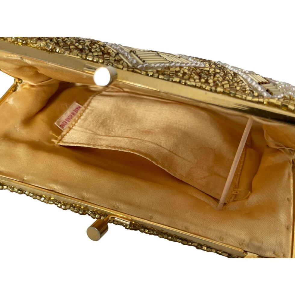 A close up of the bag only shown propped open with a small stick. The inside pocket is visible with the label Made in Hong Kong. The staining is visible on the pocket.