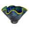 Main photo of Carlyn Ray 'Eclipse' bowl seen from an almost eye level. The bowl is entitled 'Eclipse' and has the colours but it is also a deep sea invoking colour palette with varying shades of blues and greens and bright yellow around the wide and wavy rim. The form of the bowl somehow evokes an image of a sea urchin. If turned upside down it would resemble a flowing ballerinas skirt. Gorgeous colours - definitely needs to be somewhere where light can make it dance!