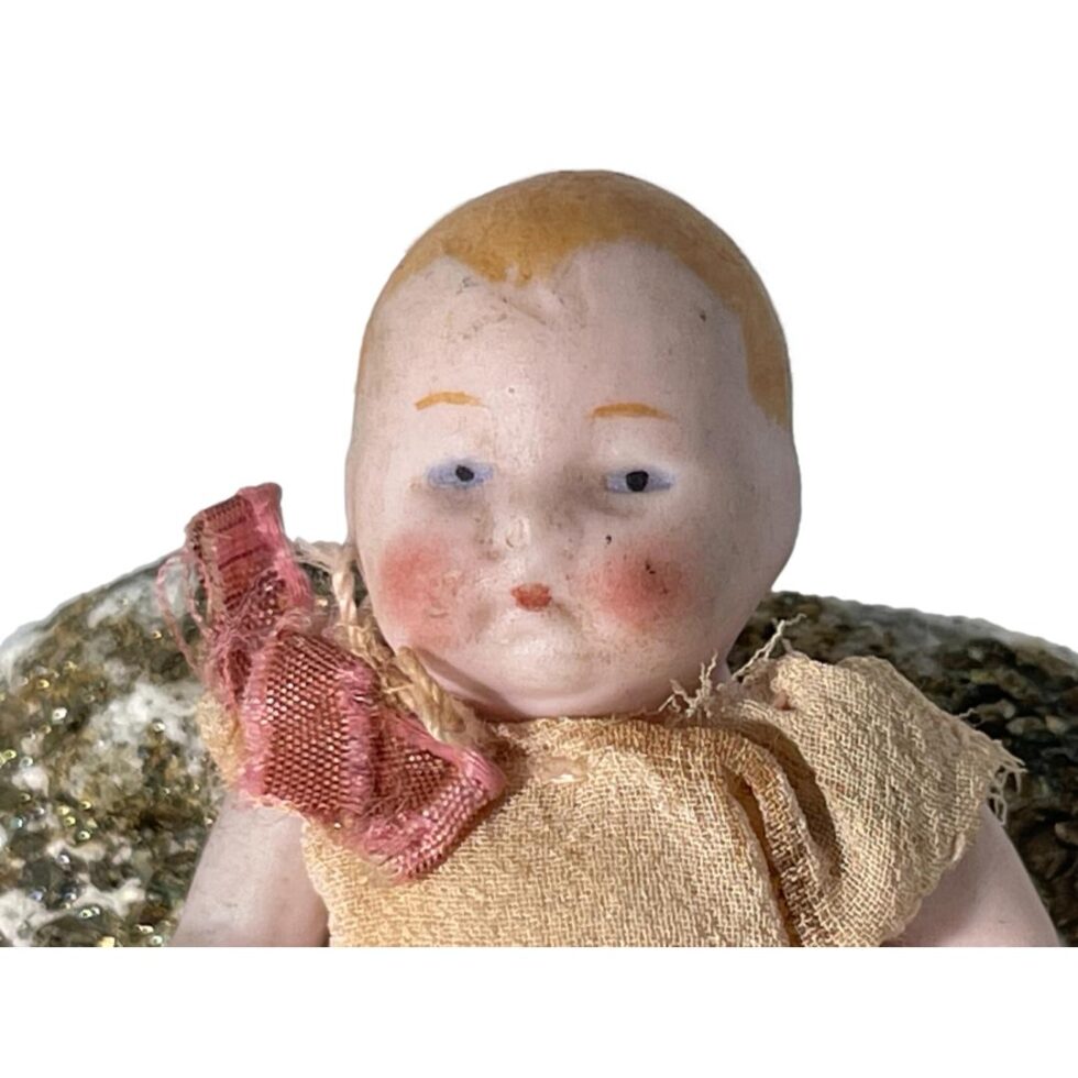 A close up of the bisque doll face showing the fine details and the dirty bits!