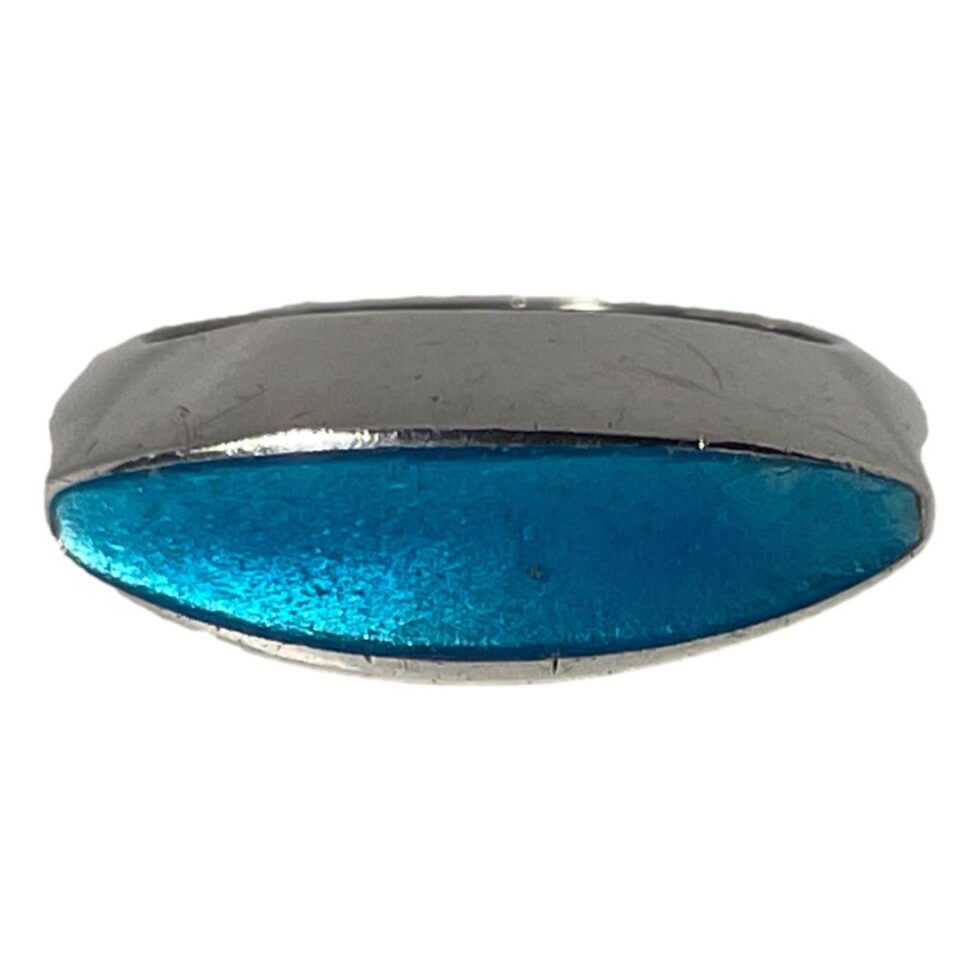Photo of Just Andersen enamel ring displayed on a flat surface with the ring front facing forward. We are looking a little more in close up at the enamel front and it really is difficult to see where the flaw is. It is in fact on the extreme right hand side.