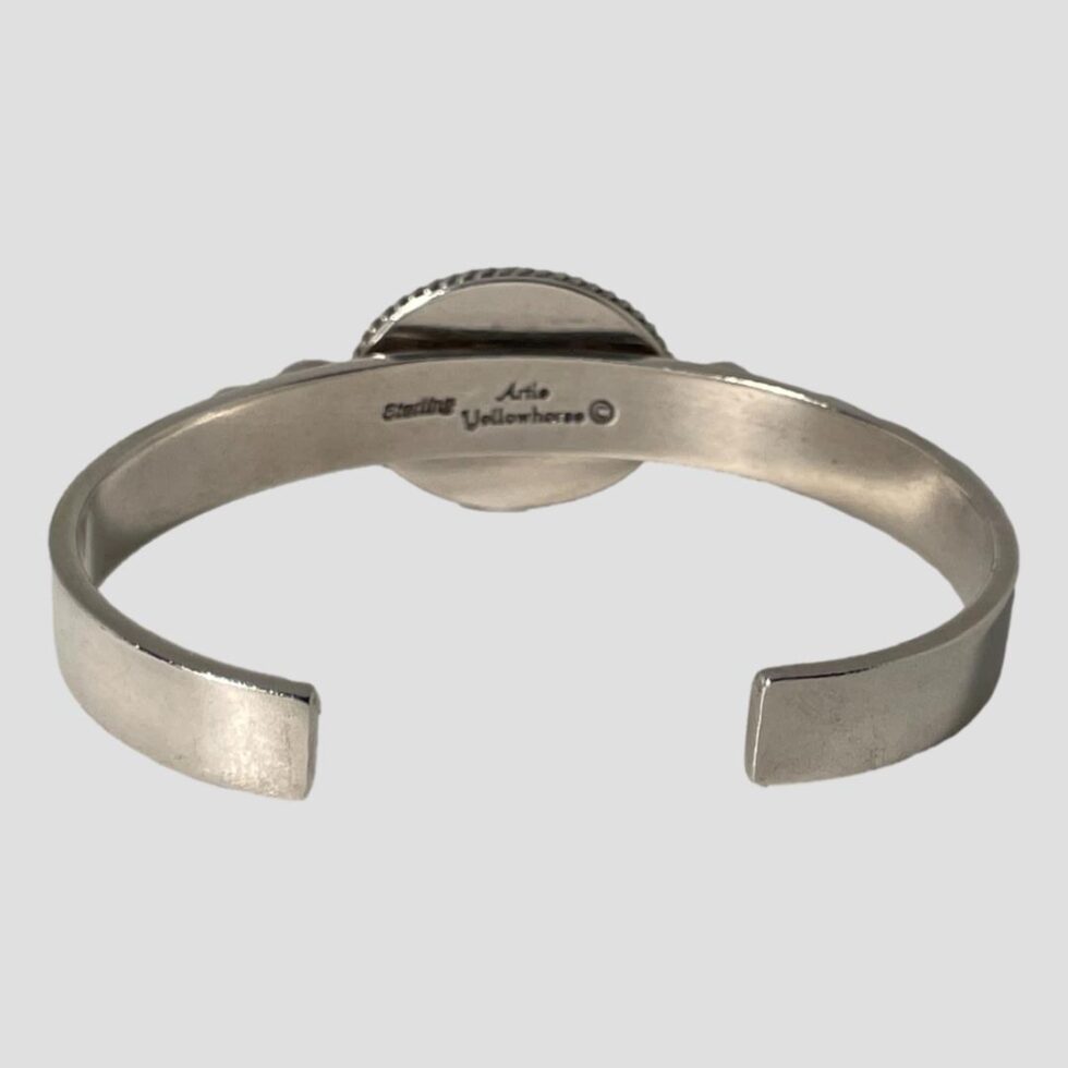 Photo of the back of the cuff bracelet showing the lapis setting above the band. The hallmark and artists mark is visible to the band.