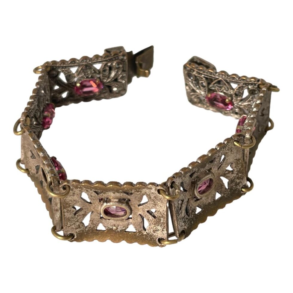Photo of Deco Czech paste bracelet displayed on a flat surface with the clasp open and the back of the panels on display. The back of the panels, although the copper is quite worn along the central areas, it does not show when the bracelet is worn.