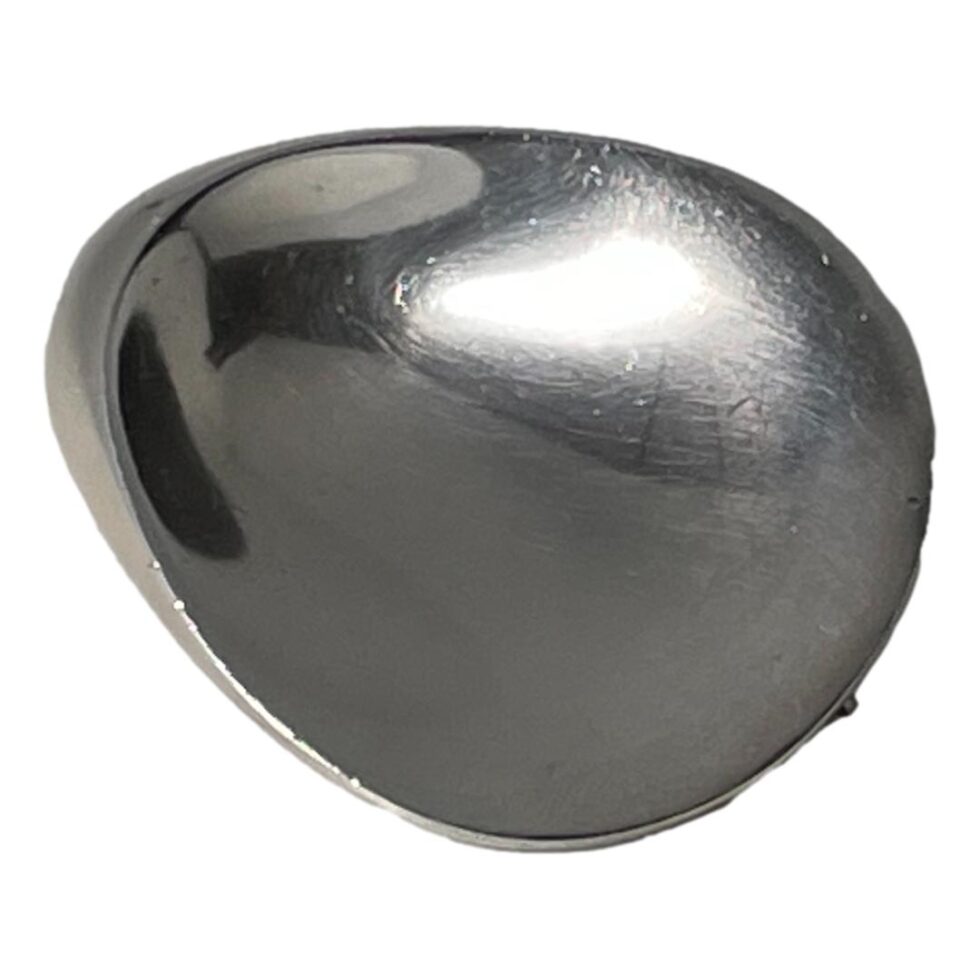 Photo of oyster brooch with smaller thicker end in the top left corner and wider side in bottom right.