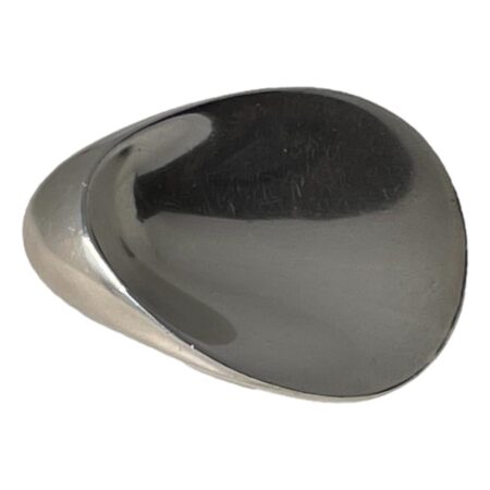 Main photo of Georg Jensen 'oyster' brooch displayed with the wider end on the right and thicker smaller end on the left. The shape is not unlike a guitar plectrum overall.