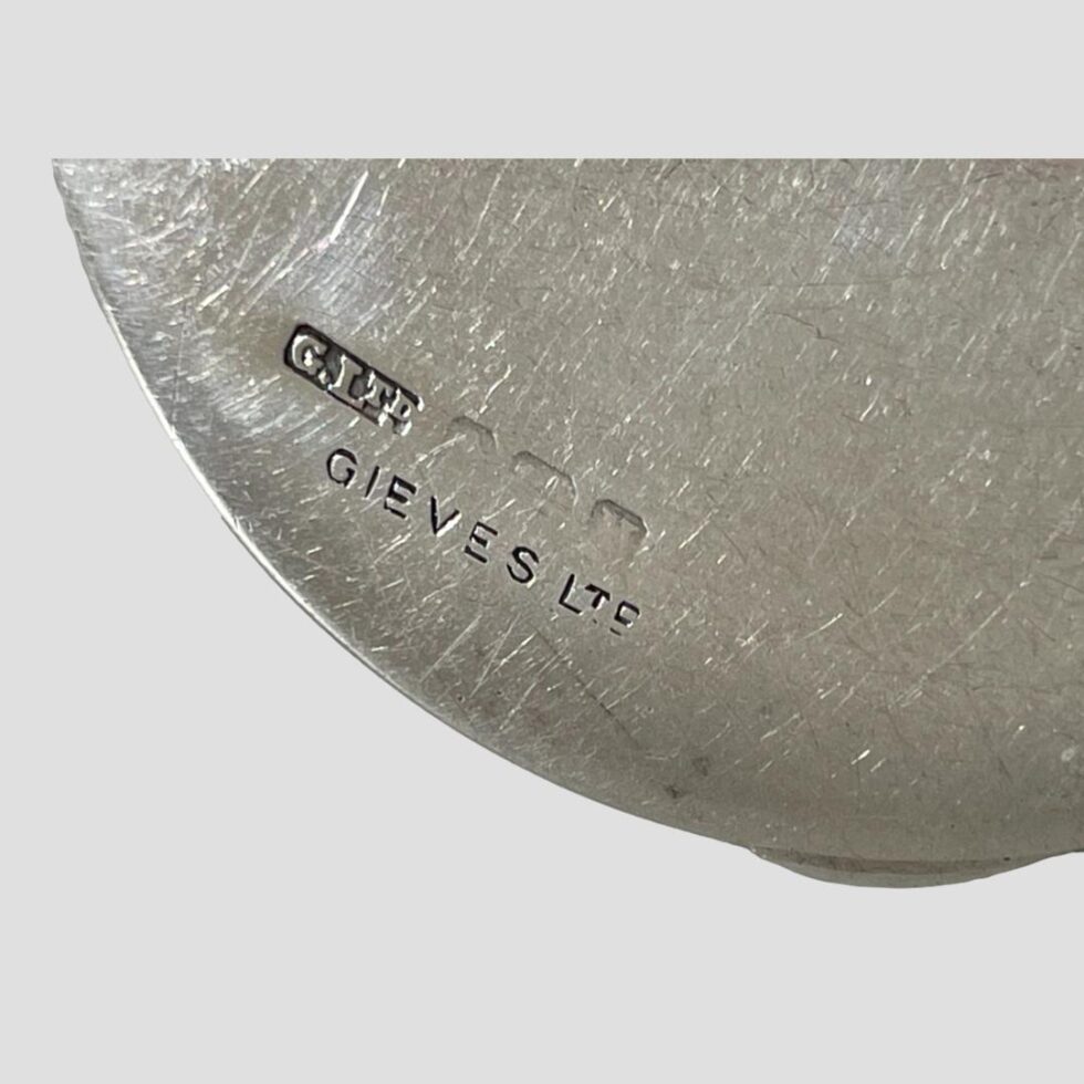 Close up photos of the makes marks G. Ltd and Gieves Ltd plus a faded full hallmark
