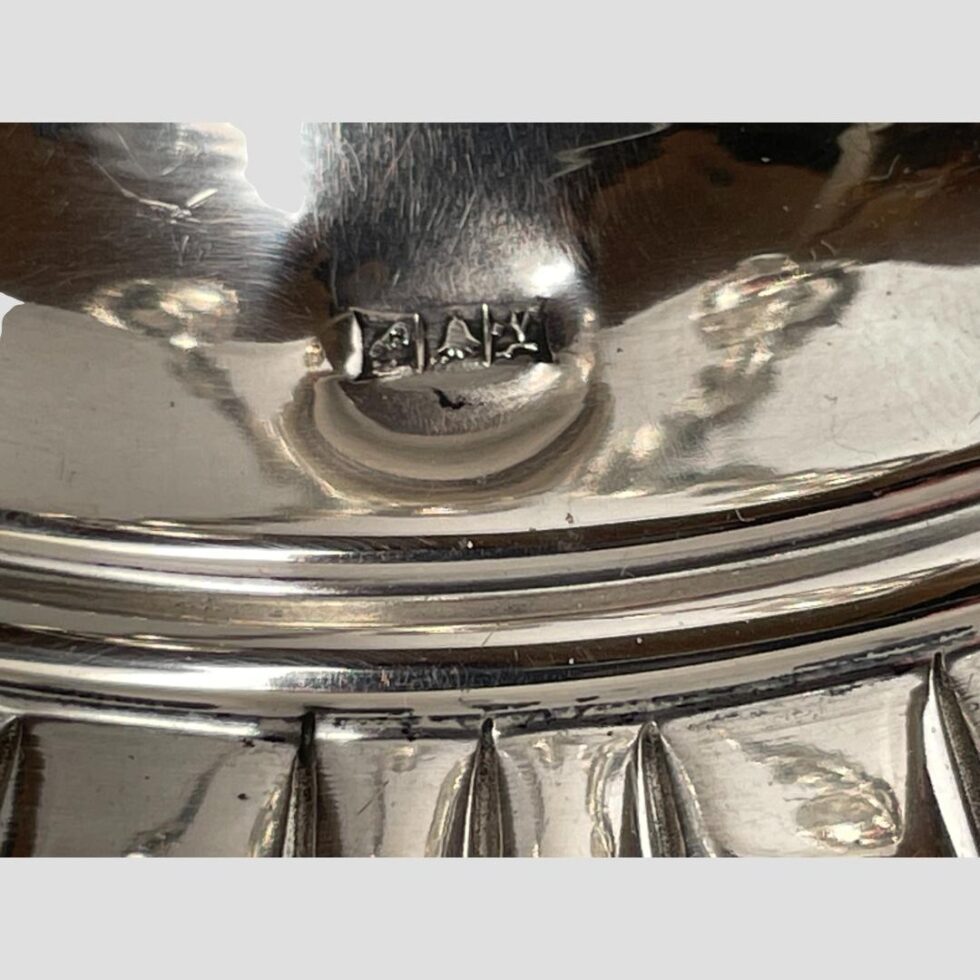 A close up of the main Egyptian silver hallmark on the plain silver part of the round base.