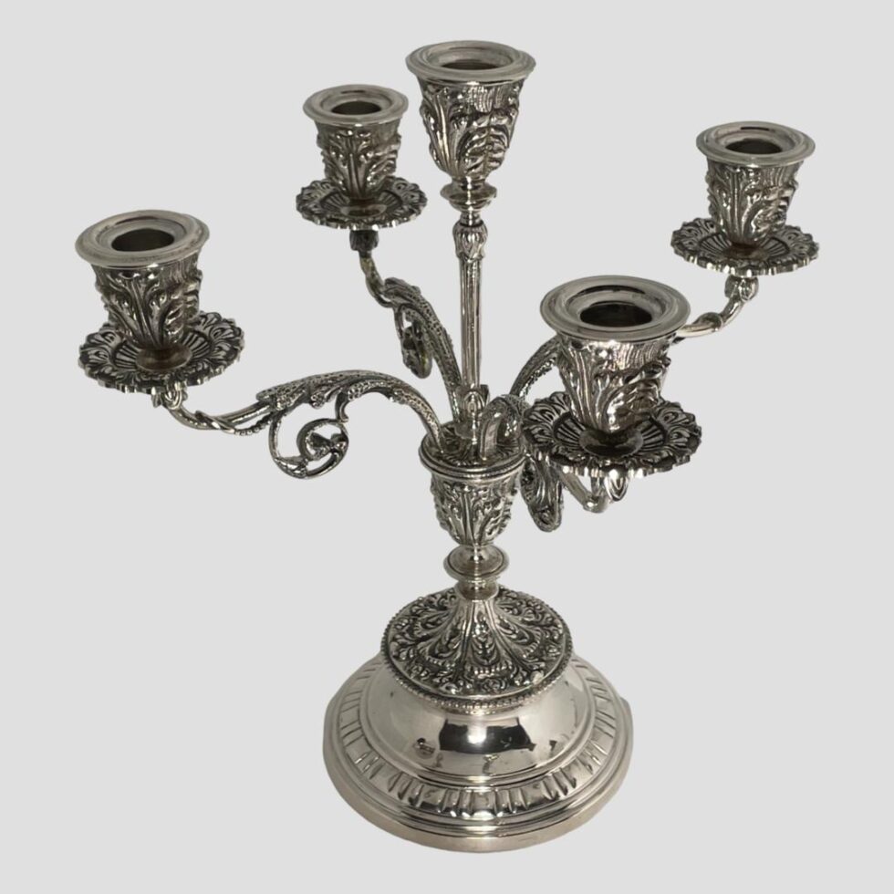 A photo of Egyptian silver candelabrum seen from a slightly raised angle looking diagonally downward showing the tops of each sconce.