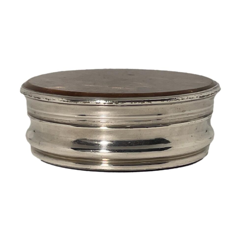 Photo of Old Sheffield plate pot seen from an eye level showing the silver plate side.