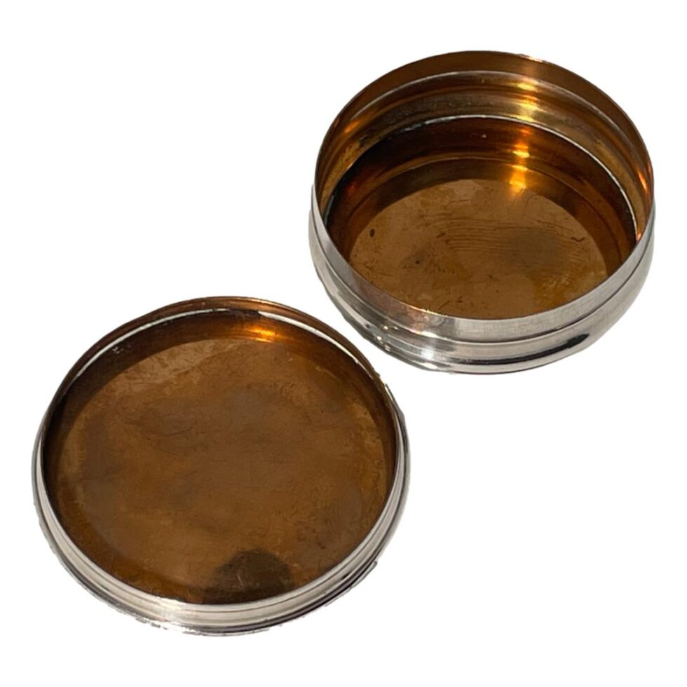 Photo of the lid now removed and placed top down to the front left of pot base. Both the base and inside of lid are copper lined.