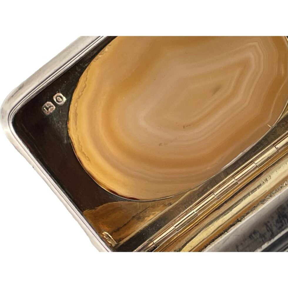 A close up photo of the short hallmark on the inside top left of the snuffbox lid.