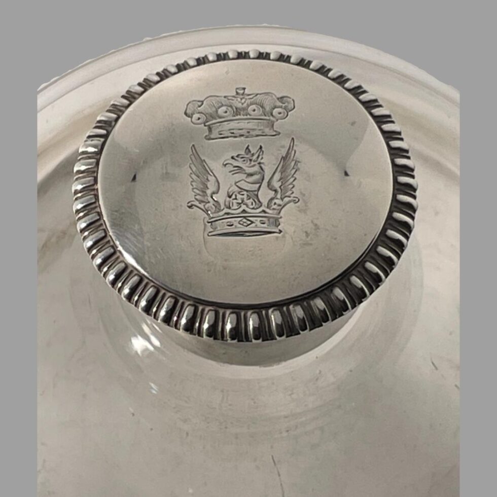 A close up photo of the crest of Victor Albert Francis Charles Spencer on the top of the silver lid.