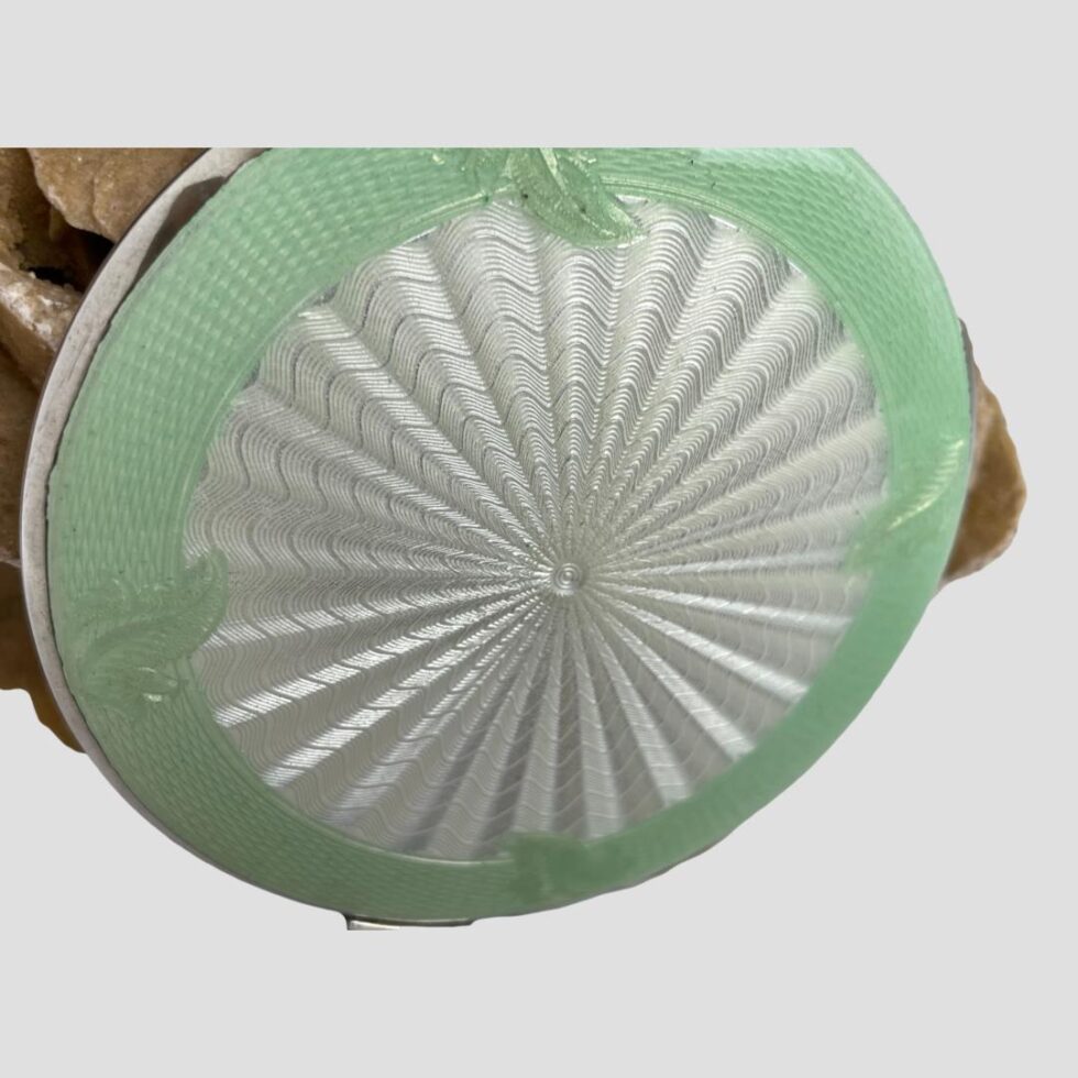 A close up of the compacts enamel lid.