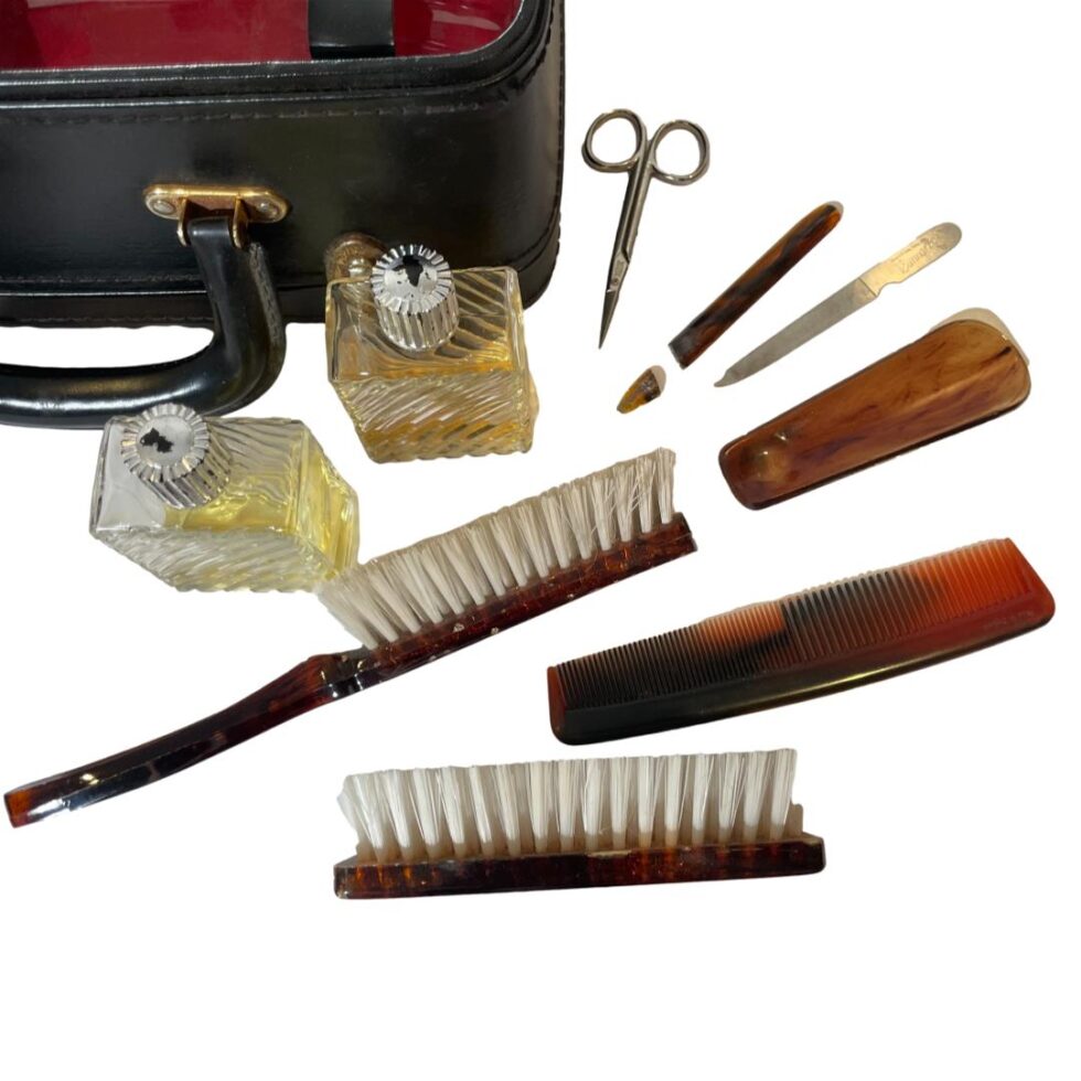 Close up photo of the contents outside of the case on the right ; nails, brushes, scent bottles.