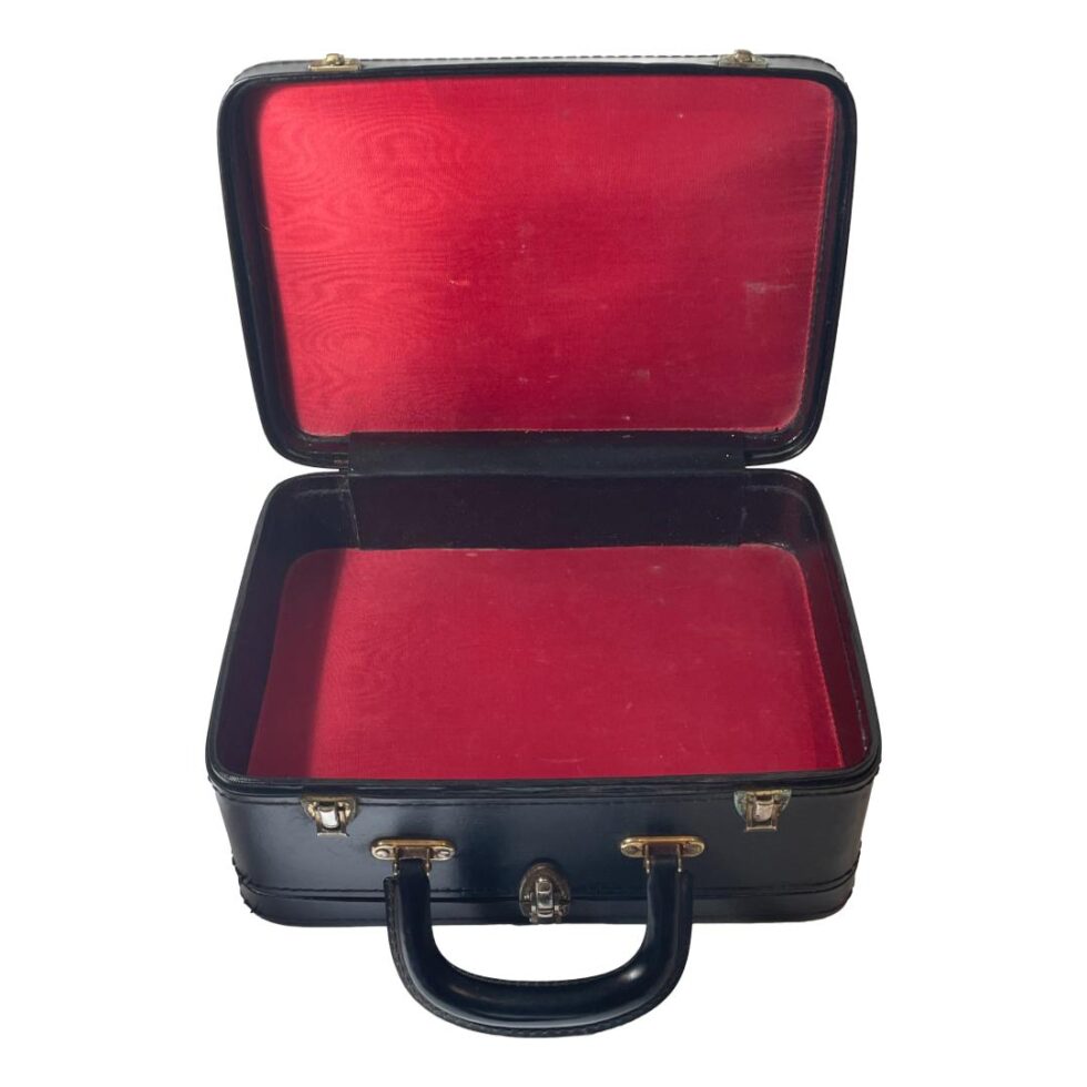 Photo of the compartment on the other side from the vanity case contents. This is a deeper compartment that could hole light clothing, perhaps under garments. The interior colour continues with the red and black theme.