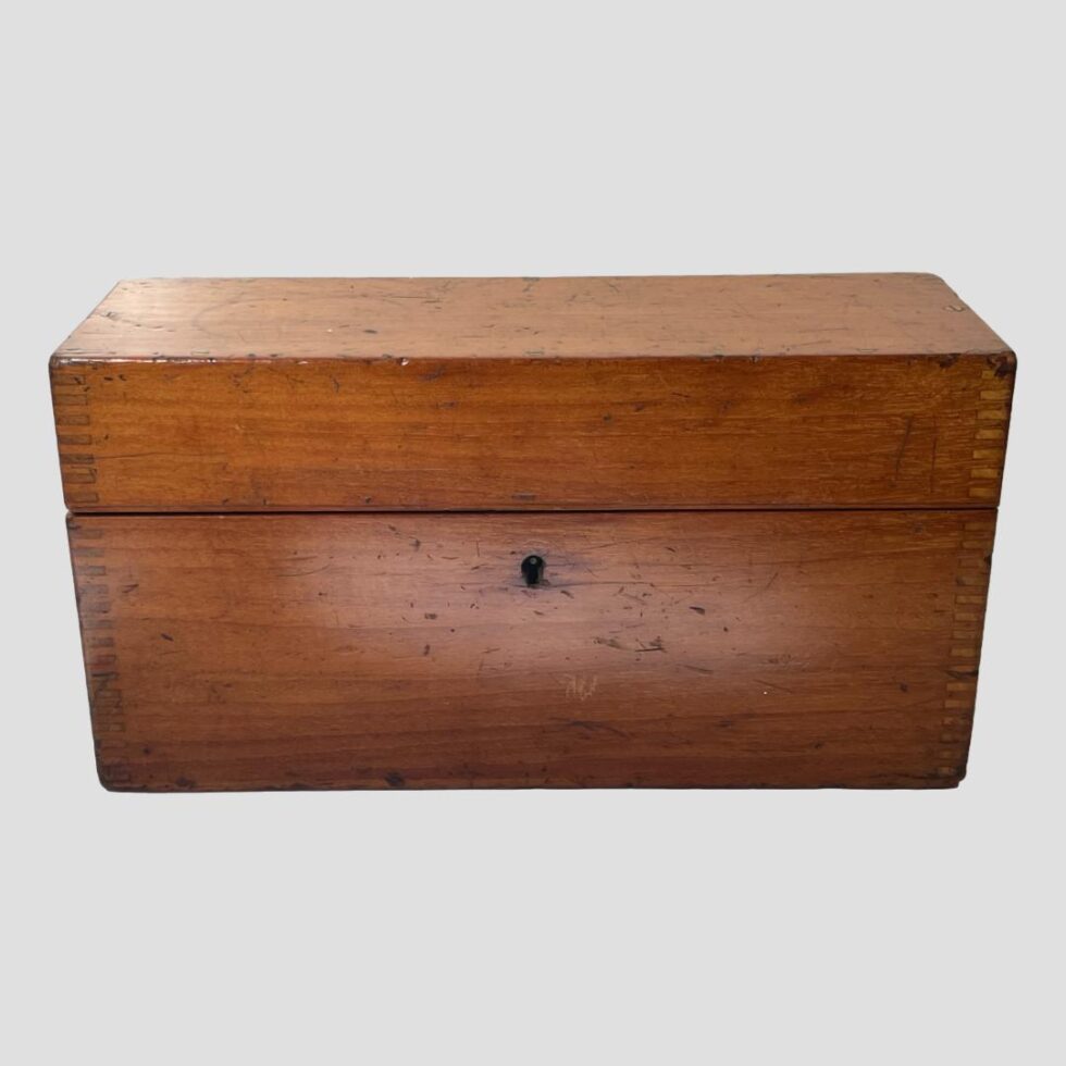 Photo of the original mahogany case housing the Stanley architects spirit level. The box is shown lengthways from the front and closed.