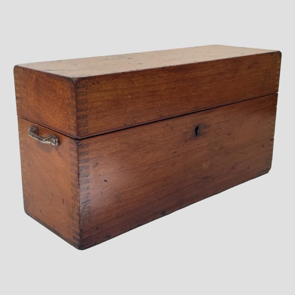 Photo of the original mahogany Stanley case this time seen at a diagonal angle with the front facing bottom right corner and one side with handle in the bottom left. Nice Knapp joint work on the corners of the box.
