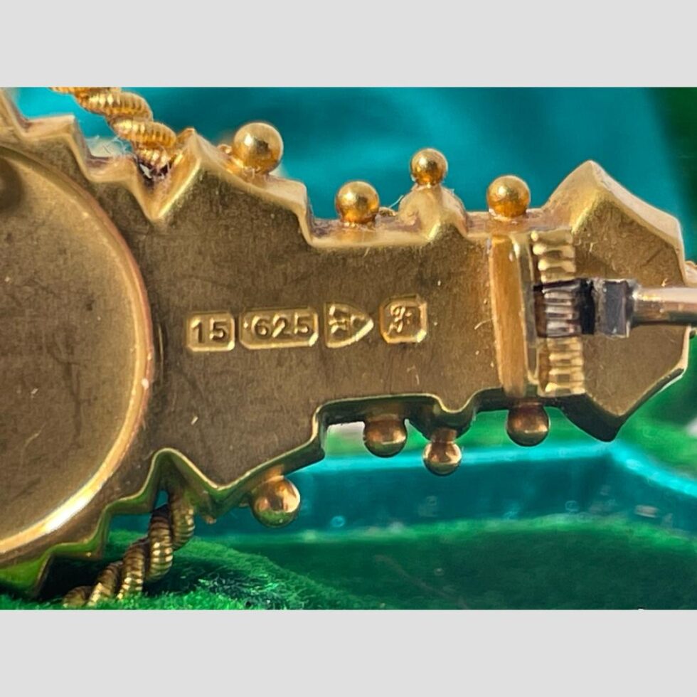 Close up photo of the full hallmark at the back of the brooch.