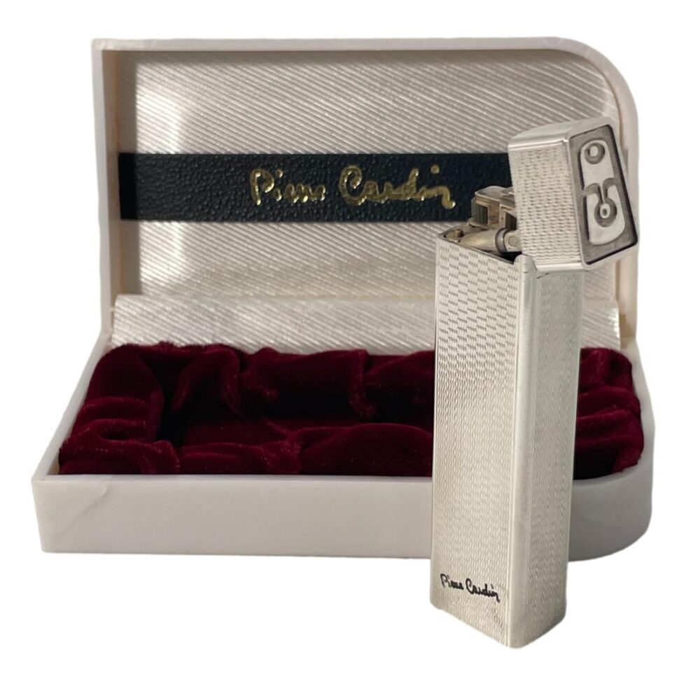 Photo of Pierre Cardin lighter displayed outside of its open box with the top flipped open.