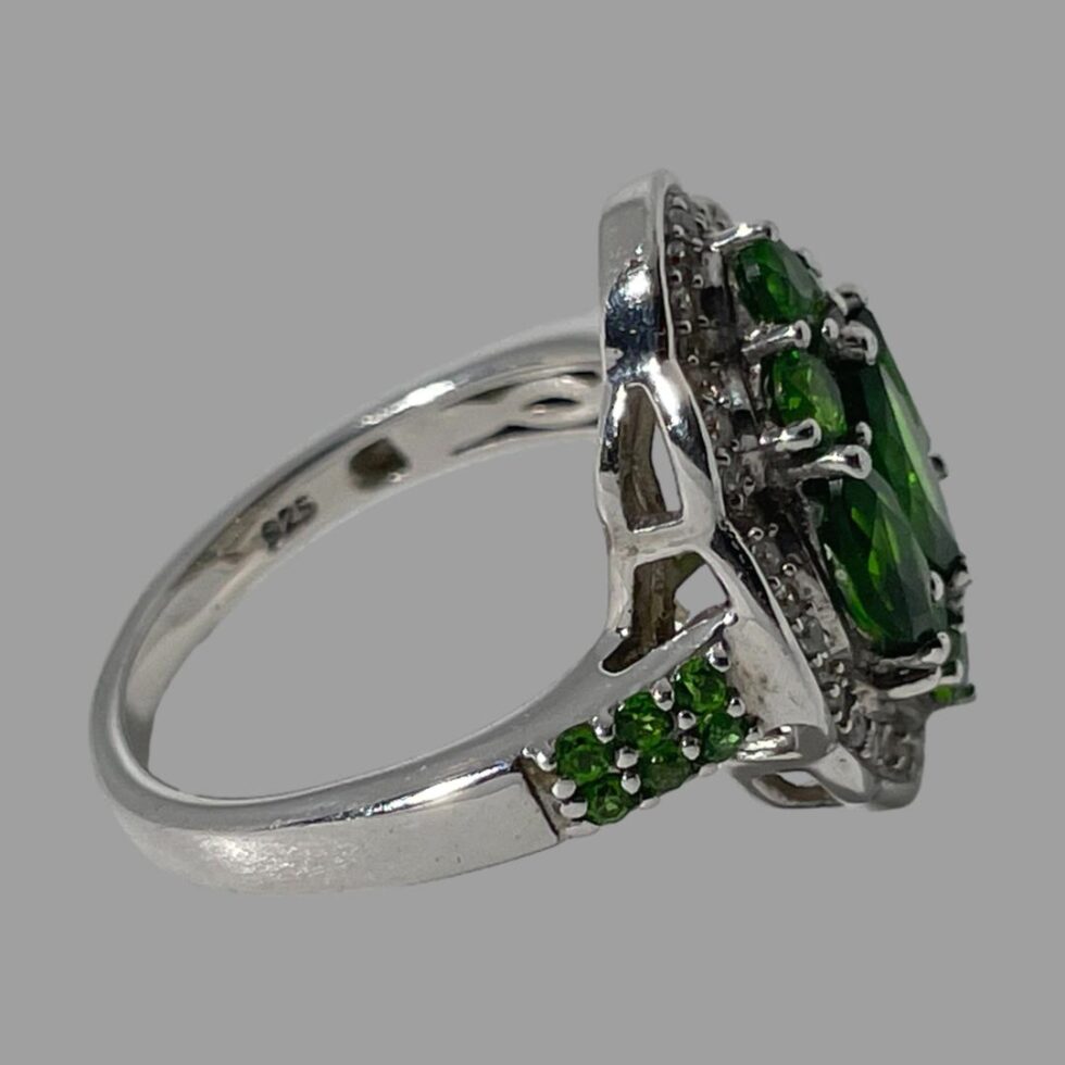 Photo of ring displayed with ring front facing right. We are looking diagonally down at the ring with the hallmark visible on the inside band.