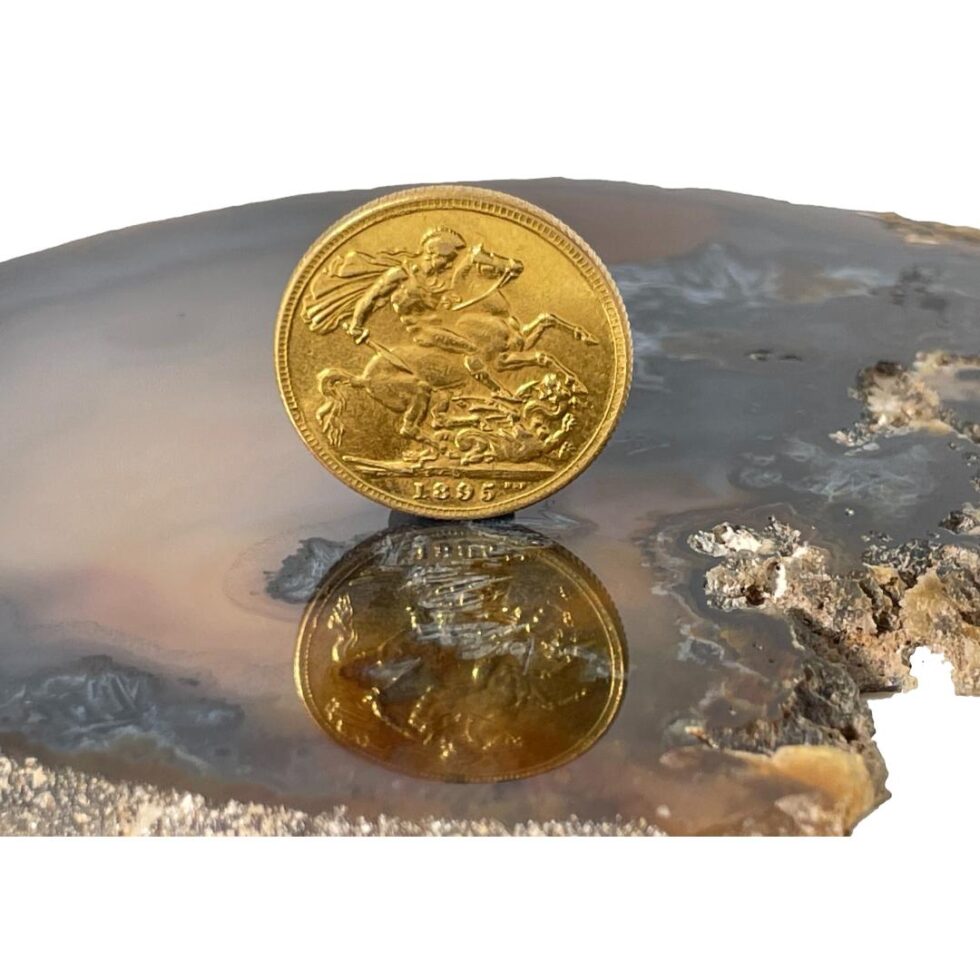 Photo of the reverse side of the 22 karat gold sovereign showing St. George on horseback poised to slaughter a dragon.