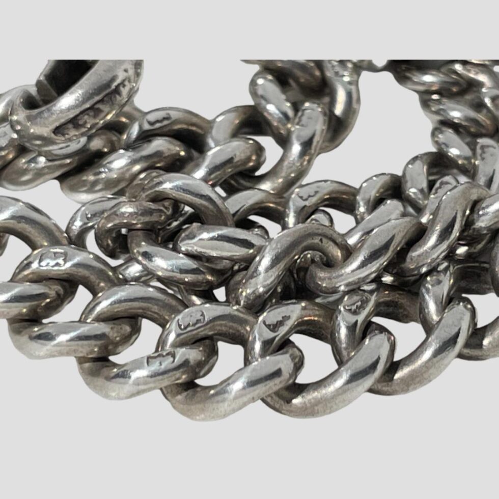 Close up photo of the chain showing some of the lion passant hallmarks which is on every chain link.