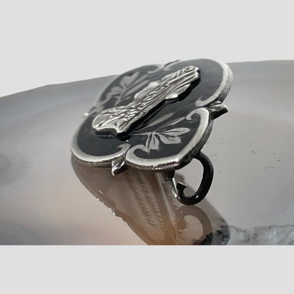 Photo of Queen Victoria brooch this time seen from a side angle to show the raised application of Queen Victoria at the centre.