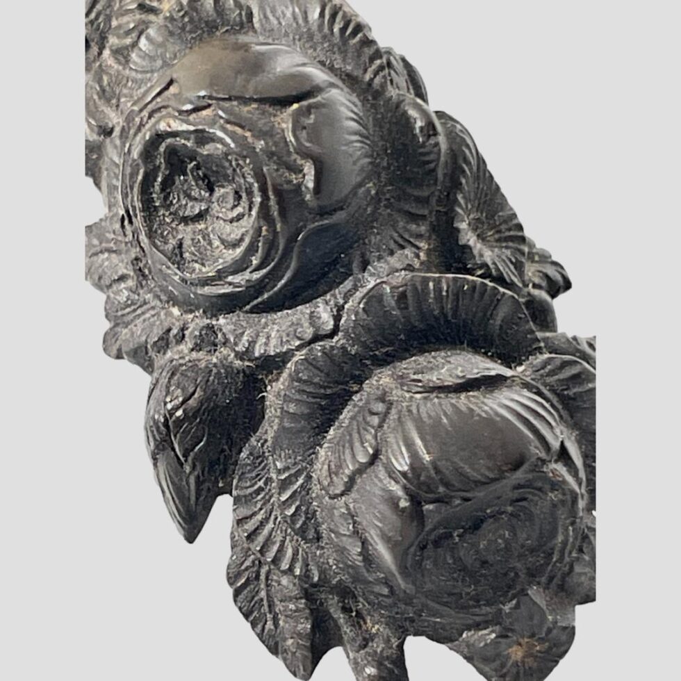 A close up of the carved floral detail at the bottom of the cross - very likely to be roses some in bloom and some buds. The carving detail is exquisite.