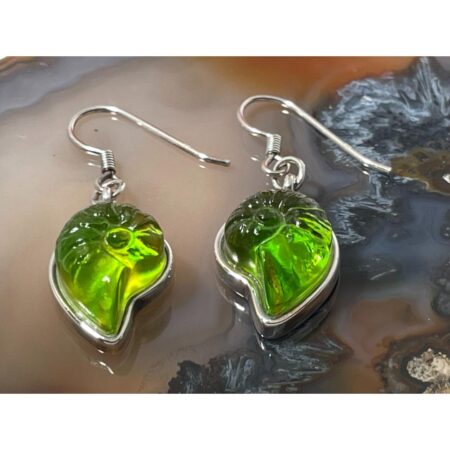 Main photo of silver crystal shell earrings displayed on top of a rock of natural agate and seen with the earring fronts forward facing. The earrings have hook fasteners with longer ends for extra security. The green of the pate-de-verre is very vibrant like a fruit jelly quality and there are hints of yellow and orange mixed in there too. Just gorgeous colours and quality earrings.