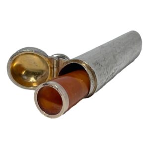 Main photo of amber cheroot & case shown wide open with the amber cheroot sticking out about halfway. The open end is facing towards the bottom left corner. The gilt inside the lid is clearly visible and in very good condition.