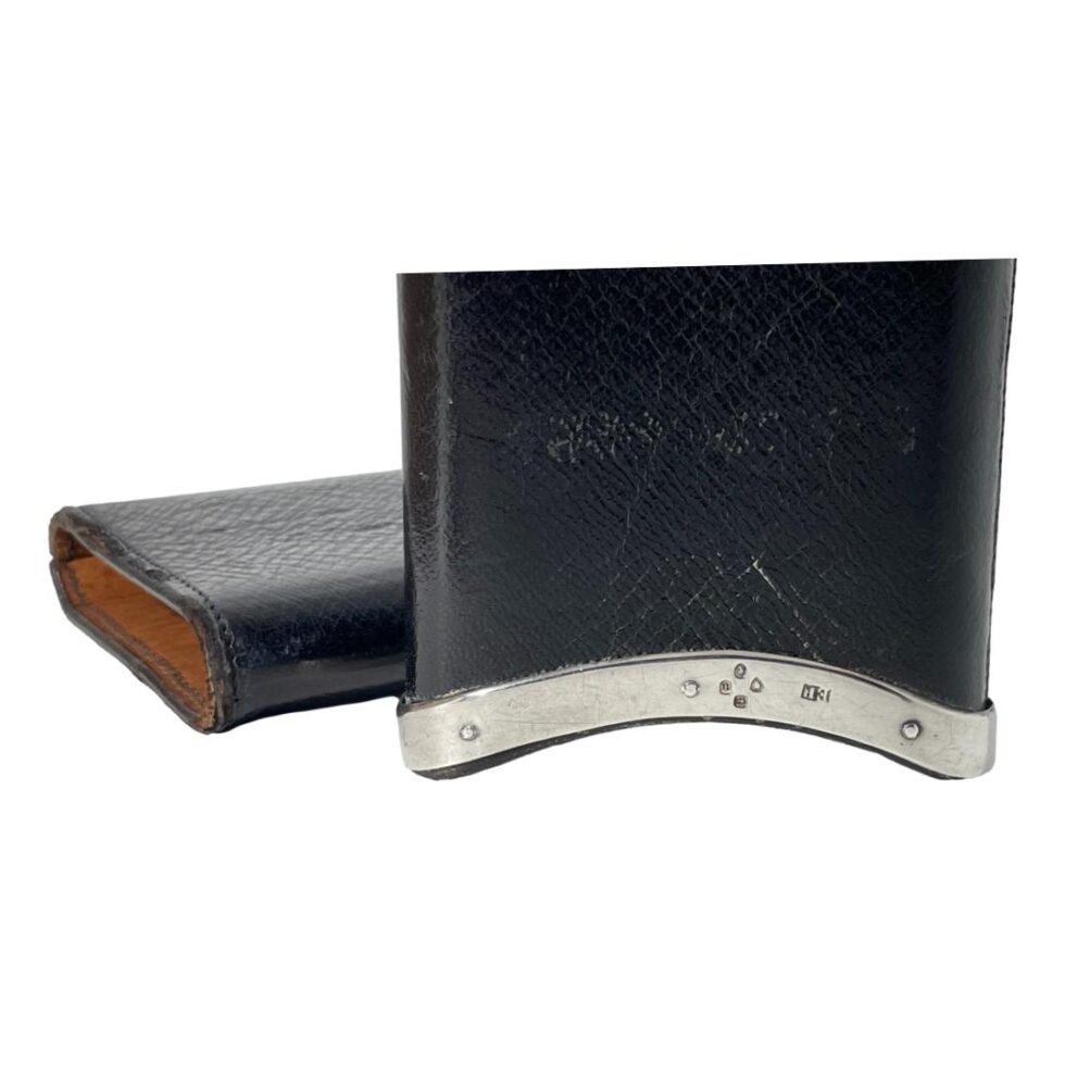 Photo of the outer pocket with silver edging displayed upright in front of the inner pocket. The hallmark is shown along the silver edge (upside down in this case)