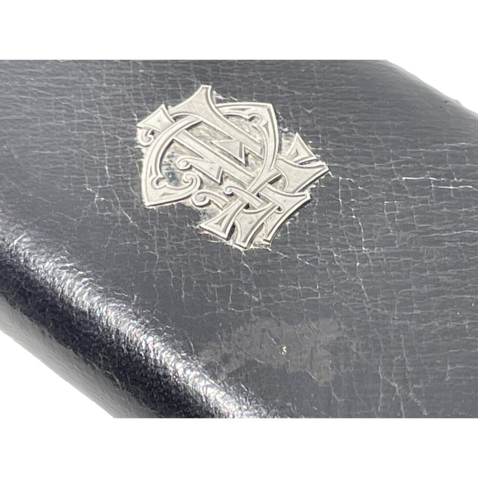A close up of the monogram area on the outer pocket of leather case.