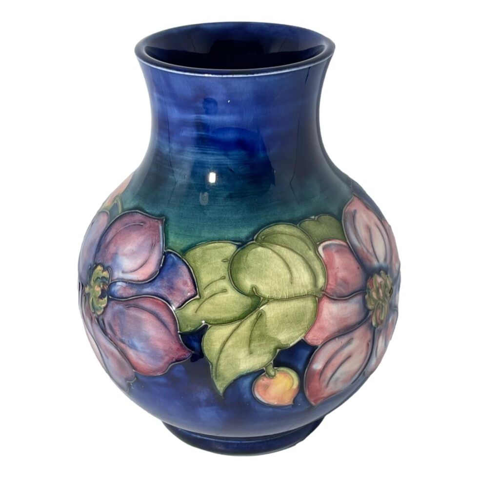 A slightly raised angle this time with the mouth of vase now visible. Purple flower to left, pink to right and light green foliage at centre.